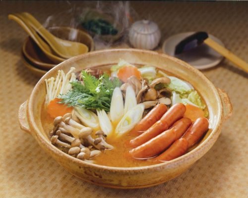 NH Foods Japanese Arabiki pork sausages served in a traditional Japanese hot pot with mushrooms and fresh vegetables.